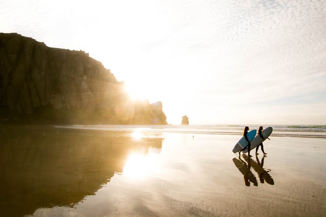 two girls with surfboards