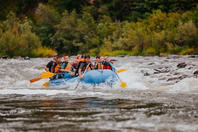 people on blue raft boat
