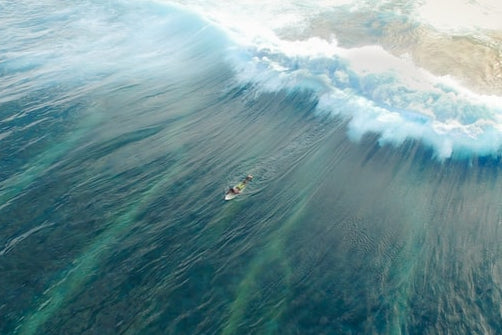 foam surfboard in big wave