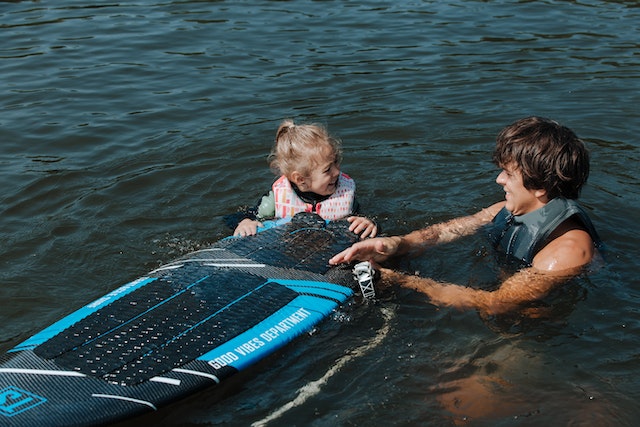 dad and daughter surfing