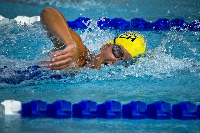 professional swimmer using ear plugs