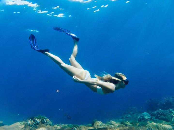 lady swimming with fins 